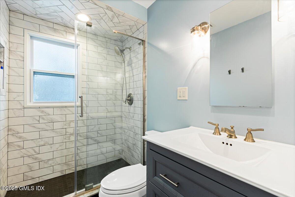 12 Mary Lane Riverside, CT 06878 - Photo 13 of 26 a bathroom with a sink a toilet and shower