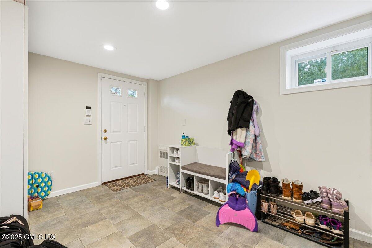 12 Mary Lane Riverside, CT 06878 - Photo 17 of 26 a bedroom with furniture and a potted plant