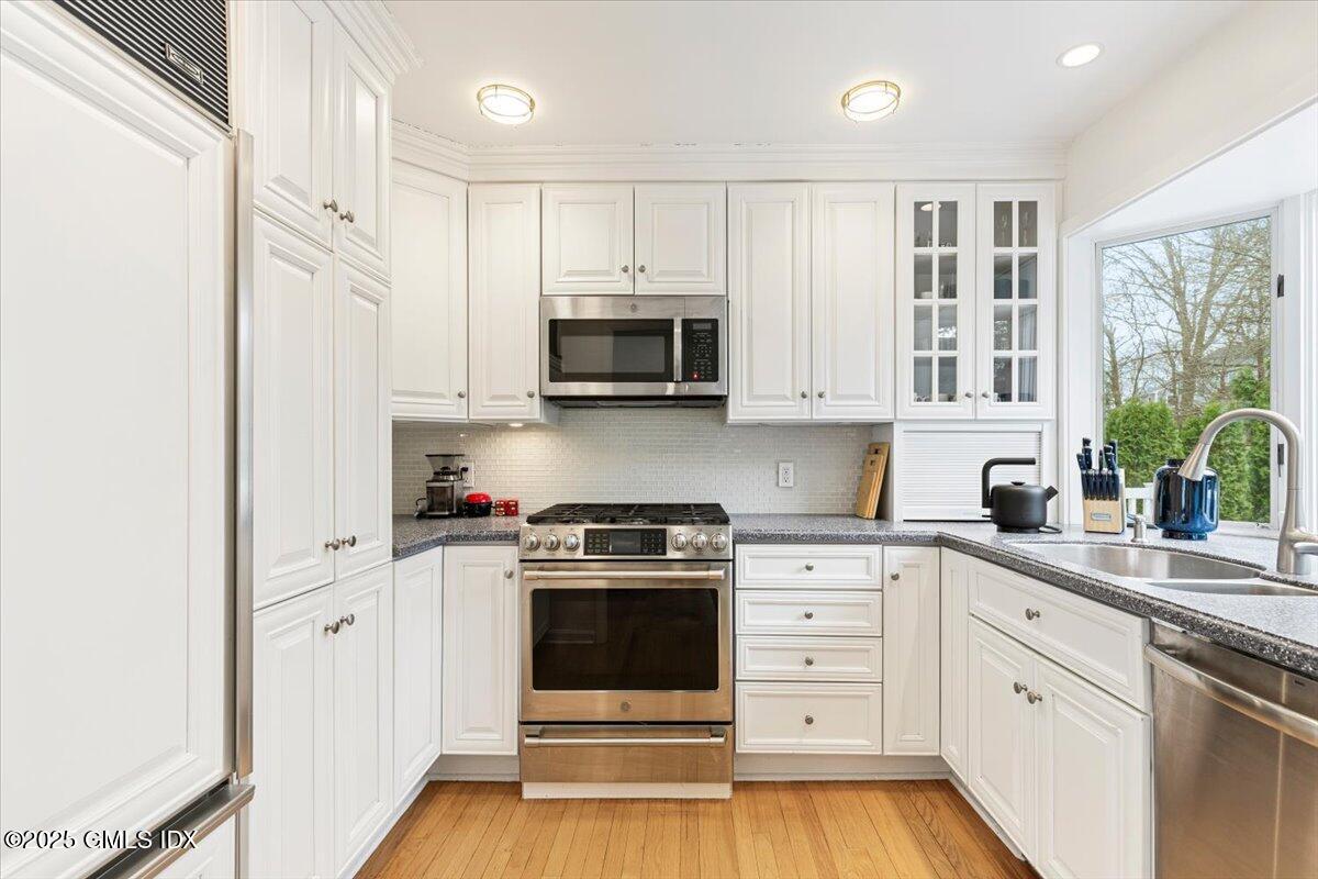 12 Mary Lane Riverside, CT 06878 - Photo 6 of 26 a kitchen with stainless steel appliances white cabinets and a stove top oven