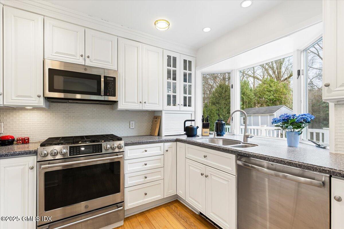 12 Mary Lane Riverside, CT 06878 - Photo 8 of 26 a kitchen with stainless steel appliances granite countertop white cabinets a sink and a stove