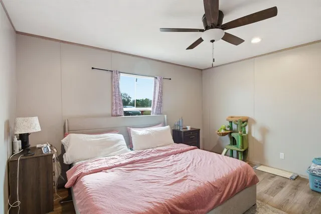 a bedroom with a bed and ceiling fan
