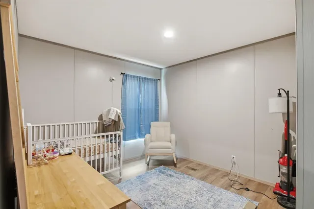 a bed room with a bed and a chair