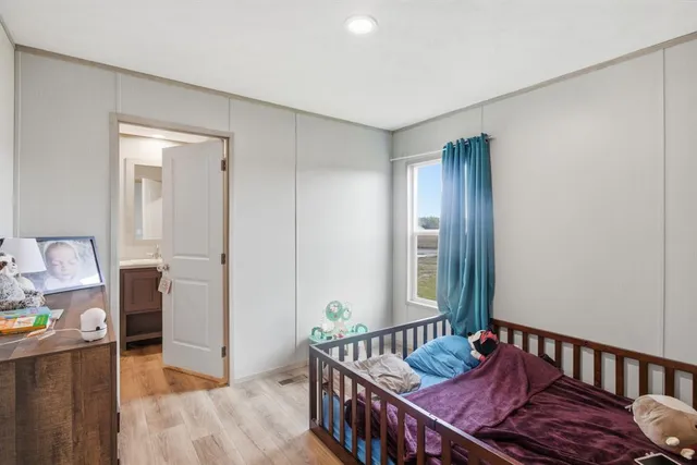 a bedroom with furniture and a window