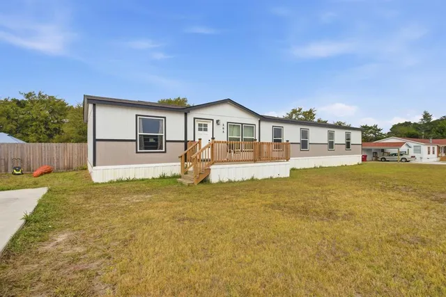 a house view with swimming pool and wooden fence