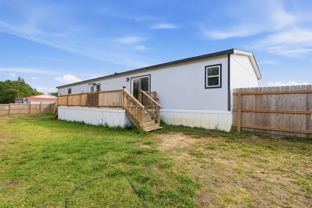 a backyard of a house with table and chairs