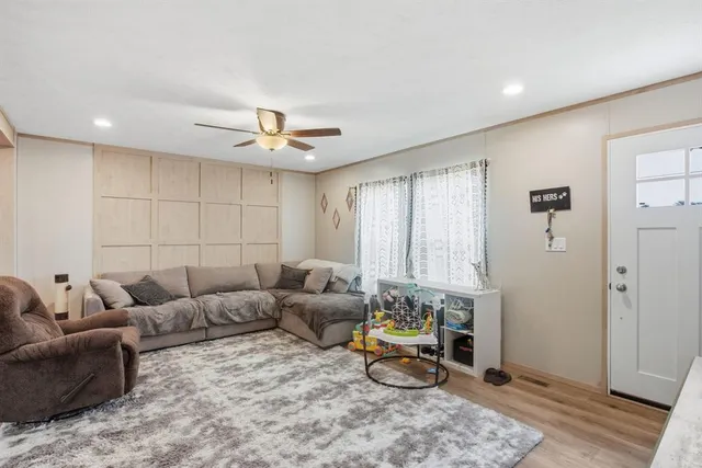 a living room with furniture and wooden floor