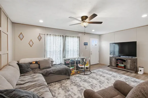 a living room with furniture and a flat screen tv