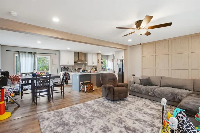 a living room with furniture kitchen view and a dining table