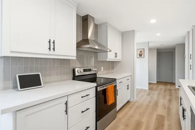 a kitchen with stainless steel appliances a stove and a sink