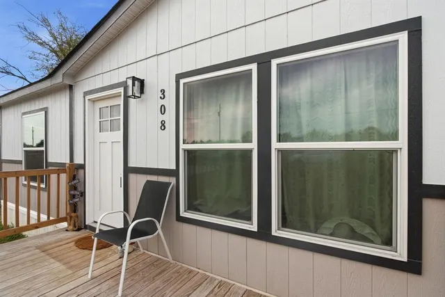 a view of a door and chair in the balcony