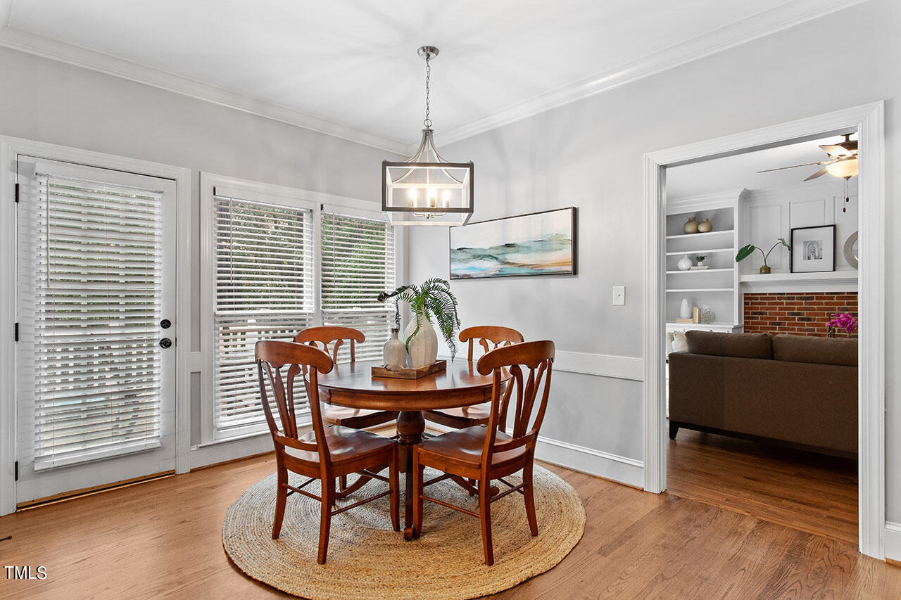 2408 Heartley Drive Raleigh, NC 27615 - Photo 14 of 41 a view of a dining room with furniture window and wooden floor