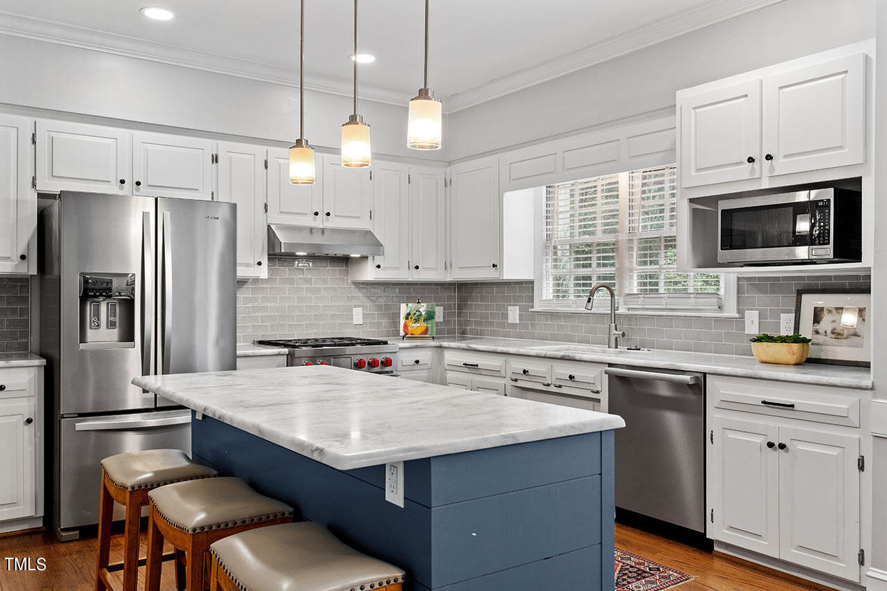 2408 Heartley Drive Raleigh, NC 27615 - Photo 15 of 41 a kitchen with a sink stove and microwave