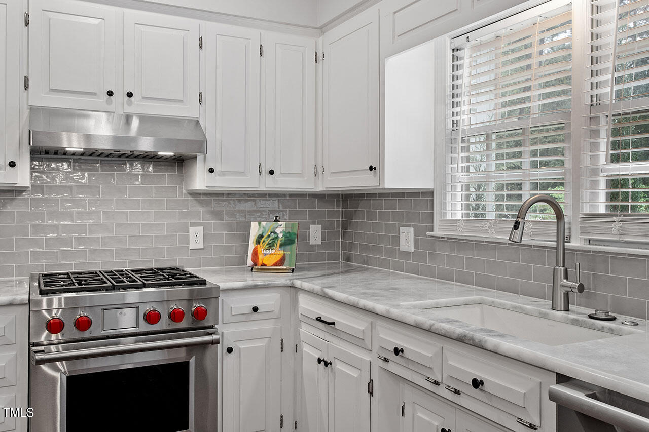 2408 Heartley Drive Raleigh, NC 27615 - Photo 16 of 41 a kitchen with stainless steel appliances granite countertop a sink a stove and a granite counter tops