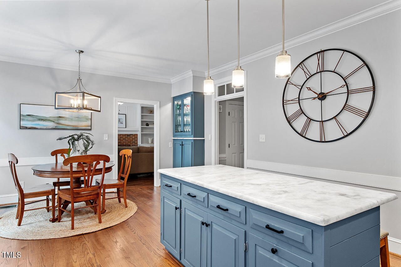 2408 Heartley Drive Raleigh, NC 27615 - Photo 17 of 41 a kitchen with stainless steel appliances granite countertop a dining table chairs and stove