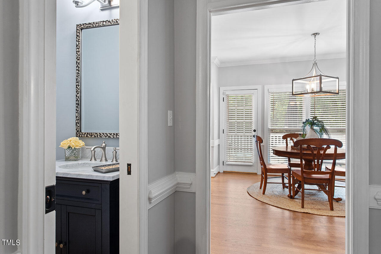 2408 Heartley Drive Raleigh, NC 27615 - Photo 19 of 41 a view of a dining room with furniture window and wooden floor