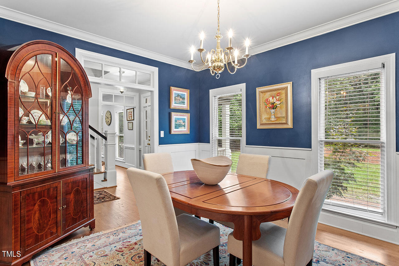 2408 Heartley Drive Raleigh, NC 27615 - Photo 23 of 41 a view of a dining room with furniture window and wooden floor