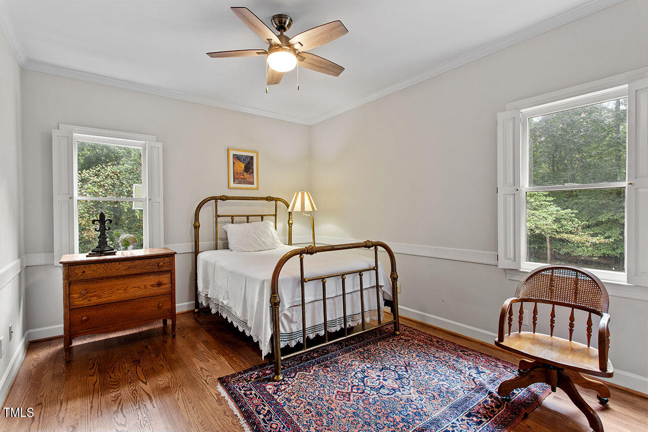 2408 Heartley Drive Raleigh, NC 27615 - Photo 24 of 41 a bedroom with a bed and a window