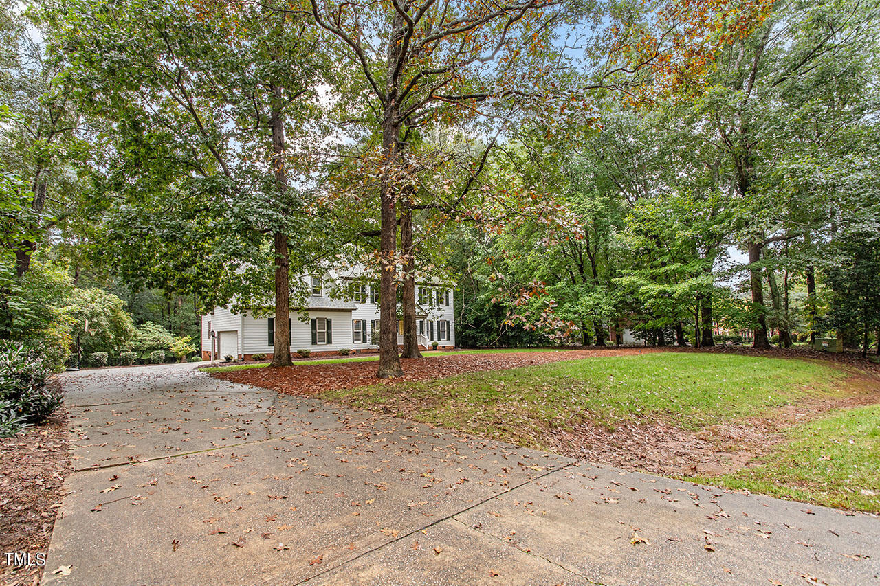 2408 Heartley Drive Raleigh, NC 27615 - Photo 3 of 41 a view of a yard with plants and trees