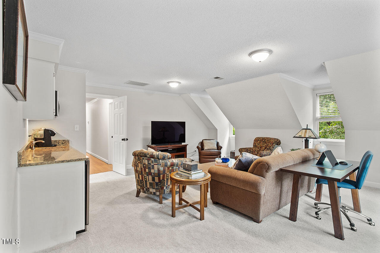 2408 Heartley Drive Raleigh, NC 27615 - Photo 33 of 41 a living room with furniture and a flat screen tv