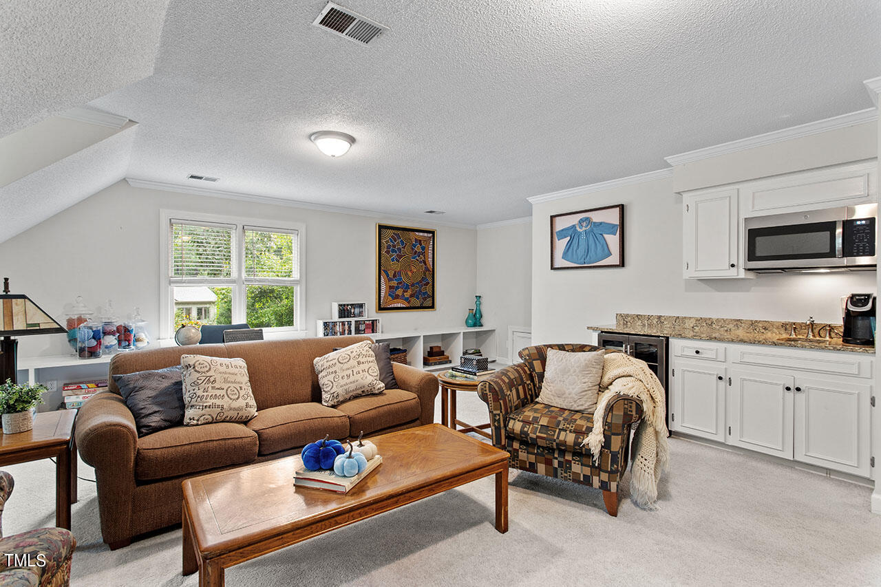 2408 Heartley Drive Raleigh, NC 27615 - Photo 34 of 41 a living room with furniture flat screen tv and window
