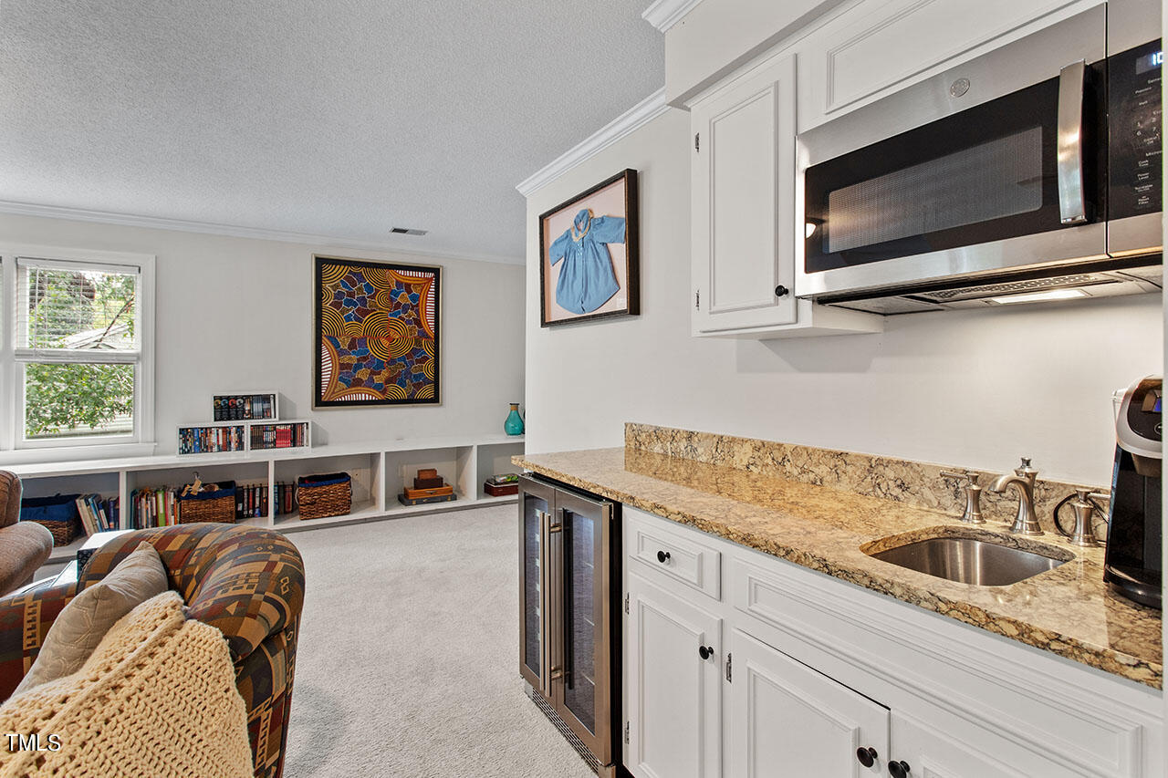 2408 Heartley Drive Raleigh, NC 27615 - Photo 35 of 41 a kitchen with a stove microwave and sink