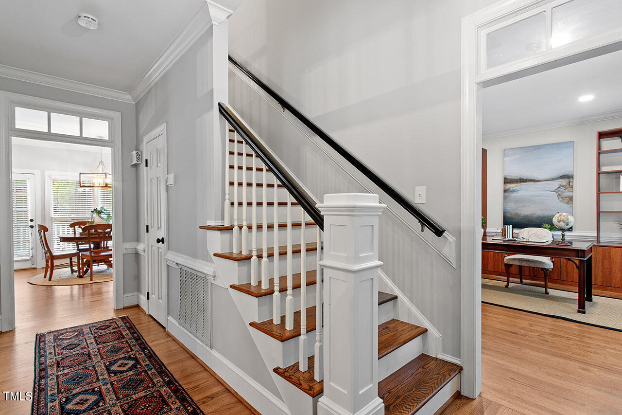 2408 Heartley Drive Raleigh, NC 27615 - Photo 4 of 41 a view of staircase with wooden floor and a rug