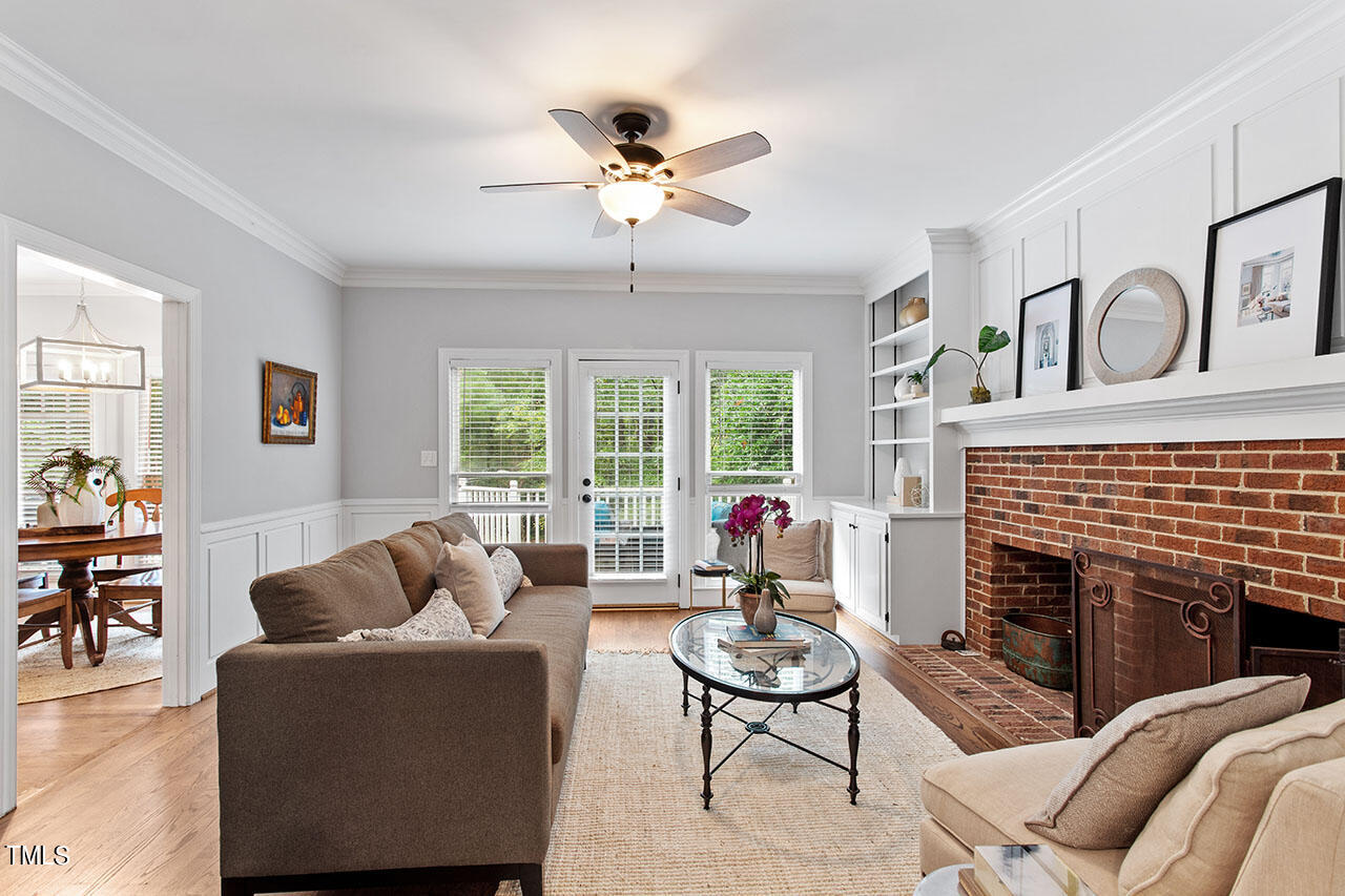 2408 Heartley Drive Raleigh, NC 27615 - Photo 10 of 41 a living room with furniture a fireplace and a large window