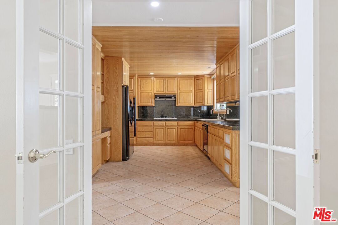 5703 Parkmor Road Calabasas, CA 91302 - Photo 12 of 29 a kitchen with stainless steel appliances granite countertop a refrigerator and a sink