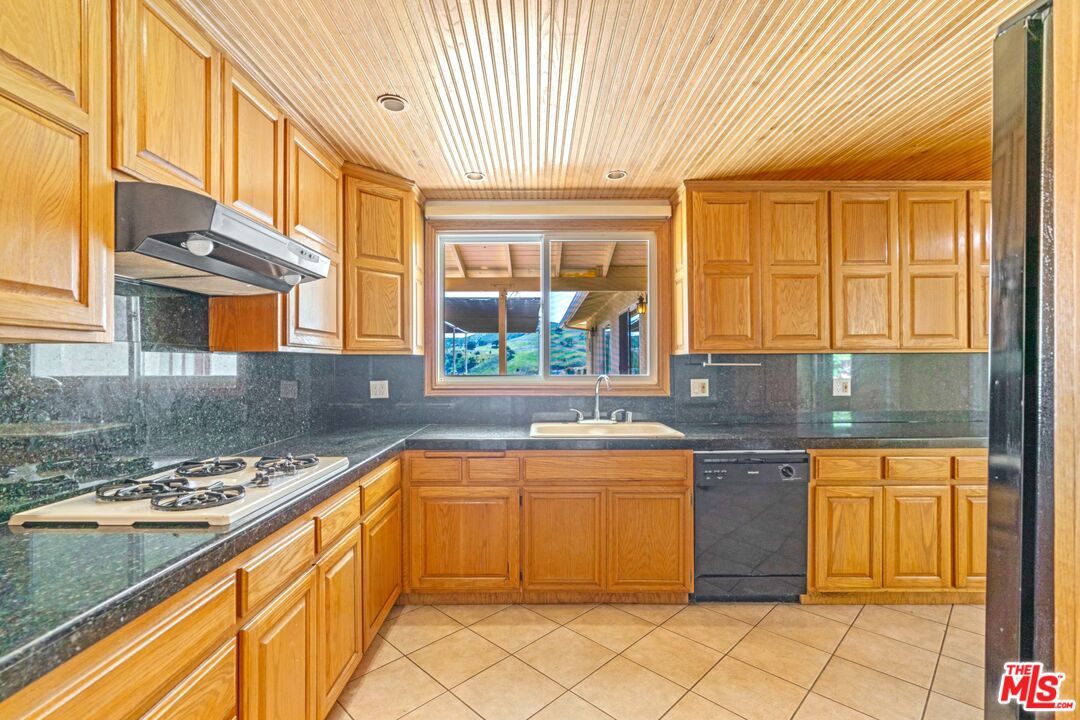 5703 Parkmor Road Calabasas, CA 91302 - Photo 15 of 29 a kitchen with stainless steel appliances granite countertop a sink and cabinets