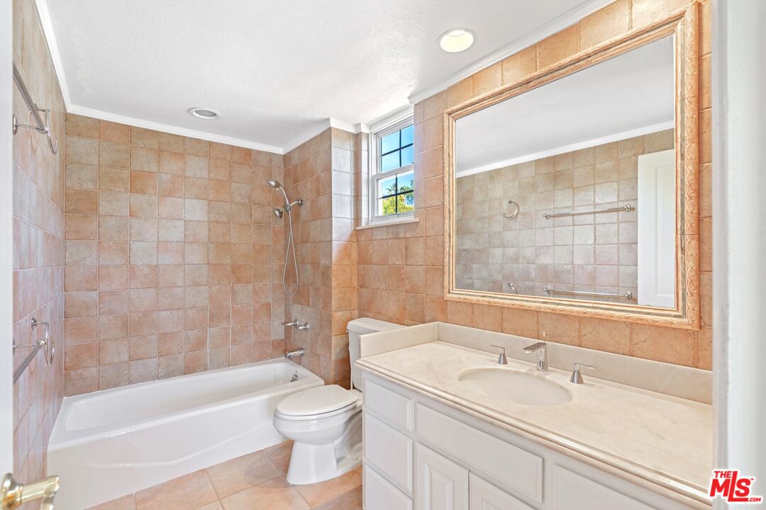5703 Parkmor Road Calabasas, CA 91302 - Photo 18 of 29 a bathroom with a granite countertop bathtub shower sink vanity mirror and toilet
