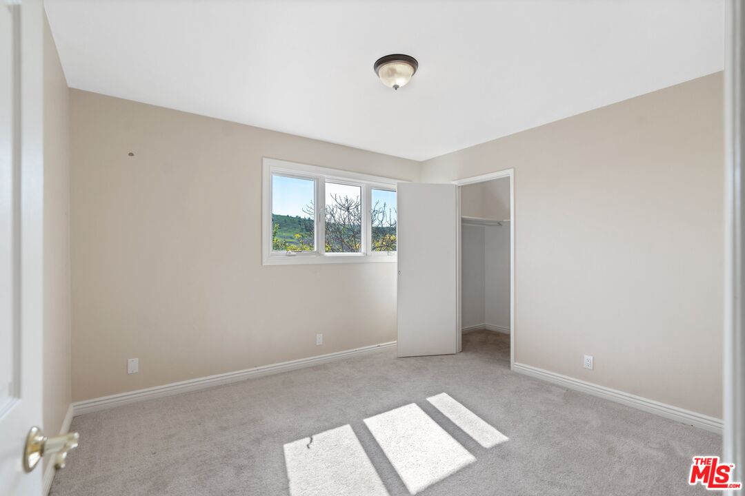 5703 Parkmor Road Calabasas, CA 91302 - Photo 20 of 29 an empty room with windows