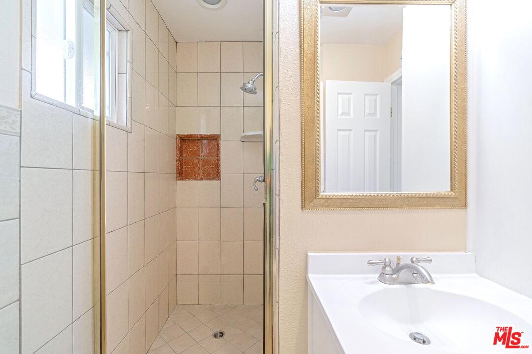 5703 Parkmor Road Calabasas, CA 91302 - Photo 22 of 29 a bathroom with a sink and a shower