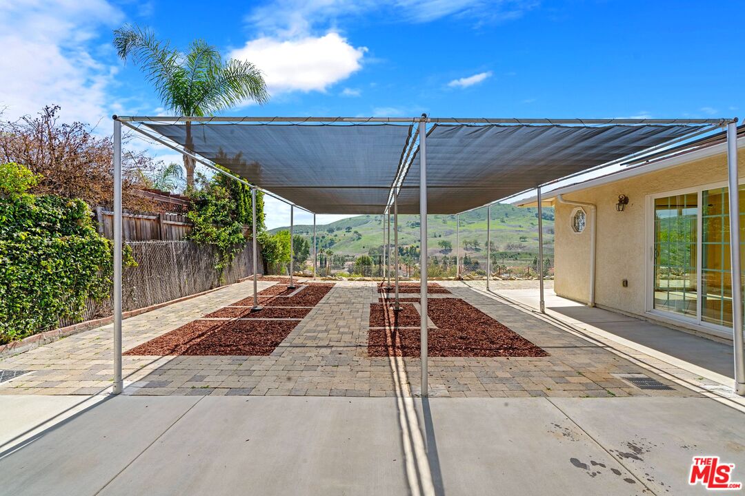5703 Parkmor Road Calabasas, CA 91302 - Photo 28 of 29 a view of a patio with table and chairs under an umbrella