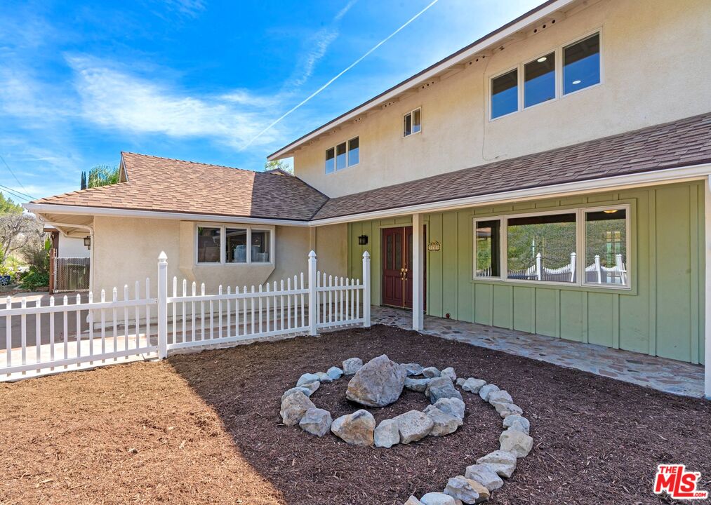 5703 Parkmor Road Calabasas, CA 91302 - Photo 3 of 29 a front view of a house with a garden