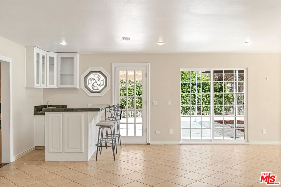 5703 Parkmor Road Calabasas, CA 91302 - Photo 5 of 29 a view of a hallway with wooden floor and a bookshelf