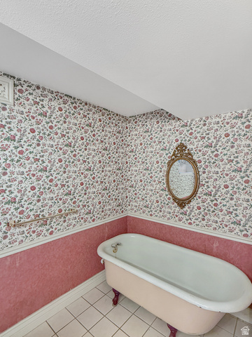 1716 Sagewood Road Price, UT 84501 - Photo 42 of 73 Bathroom featuring wallpapered walls, a soaking tub, light tile patterned floors, and a textured ceiling