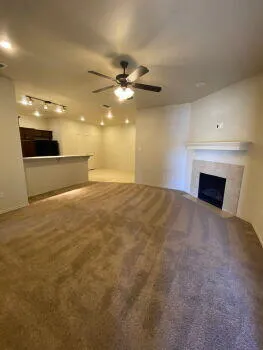 a view of empty room with a fireplace