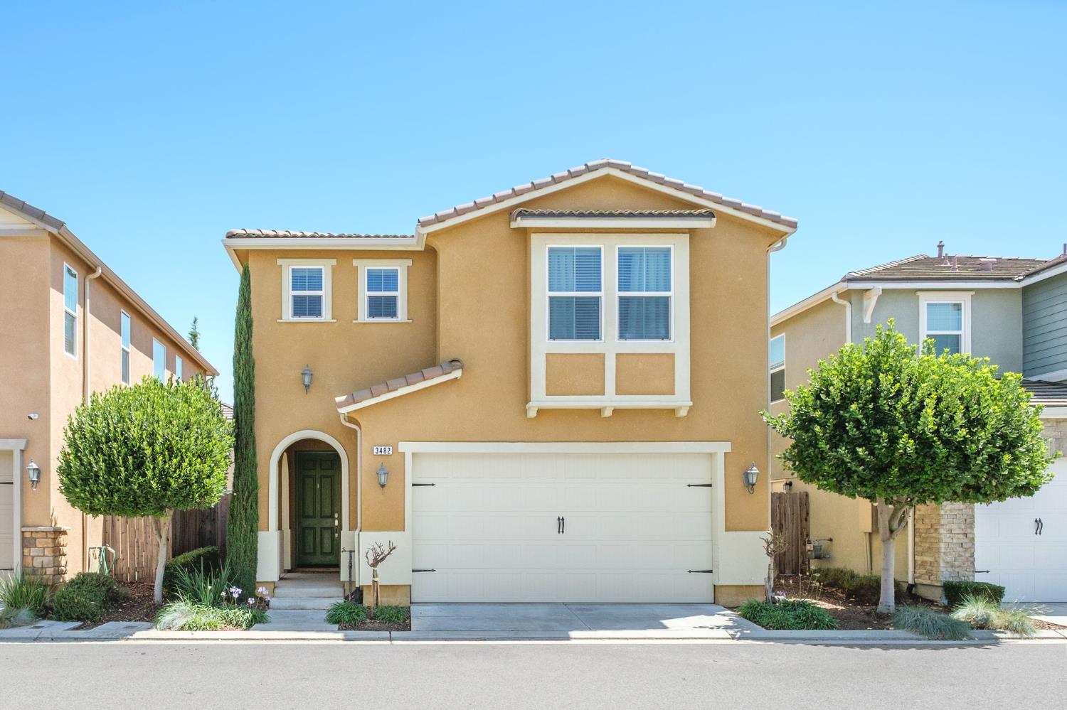 3482 Elevations Way Clovis, CA 93619 - Photo 2 of 29 a front view of a house with a yard