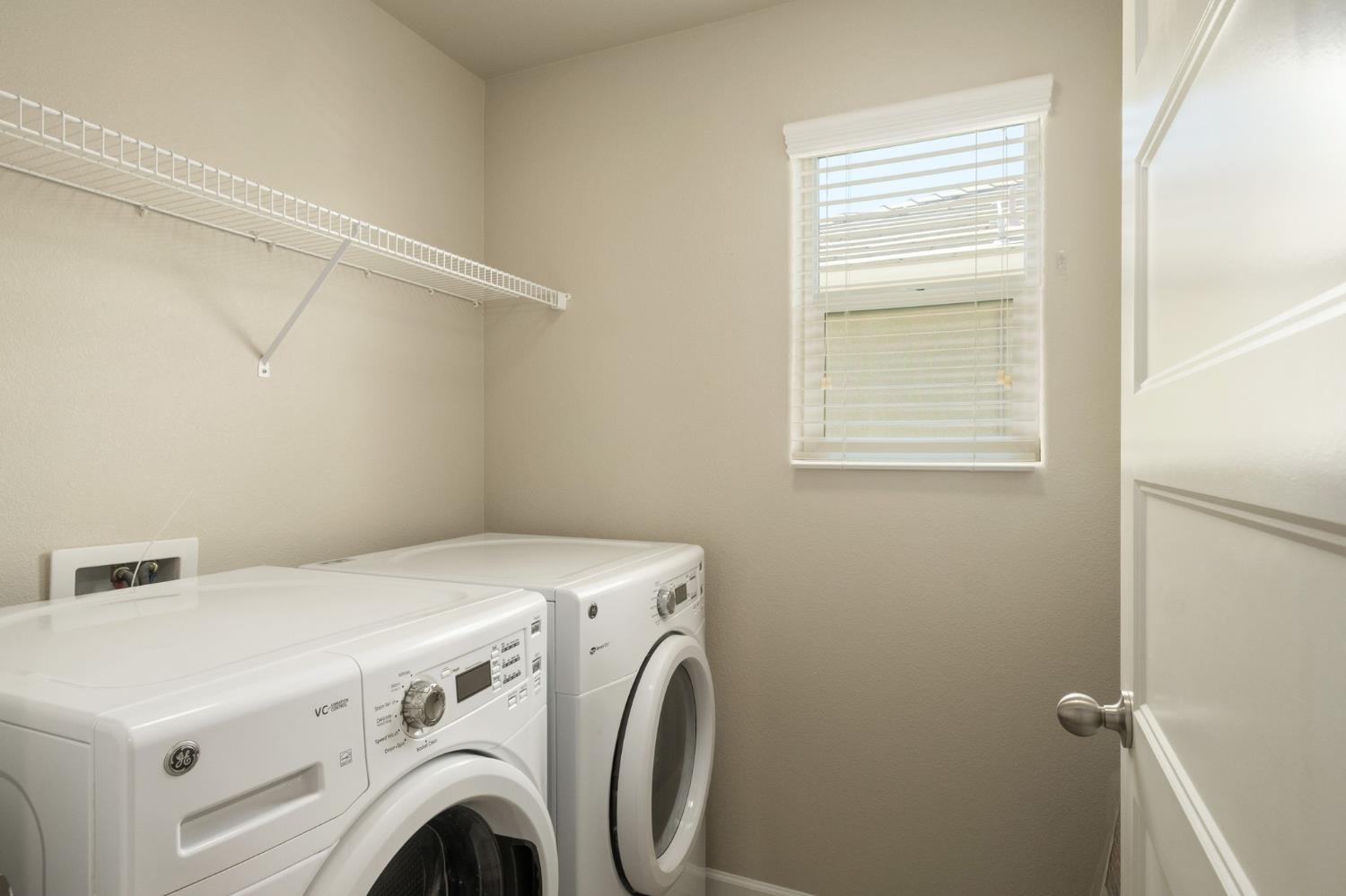 3482 Elevations Way Clovis, CA 93619 - Photo 23 of 29 a utility room with dryer and washer