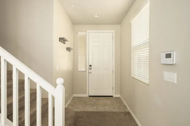 a view of a hallway with windows and stairs