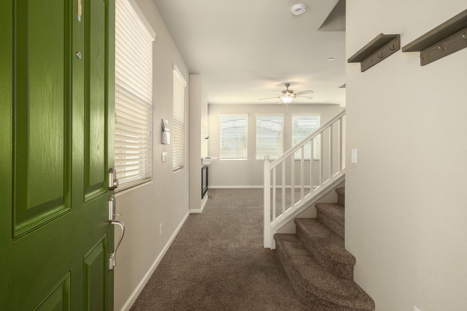 3482 Elevations Way Clovis, CA 93619 - Photo 6 of 29 a view of a hallway with windows and stairs