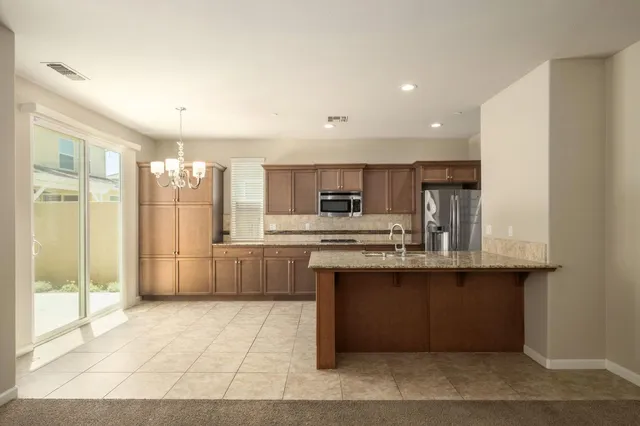 a spacious bathroom with a granite countertop sink a mirror and a shower