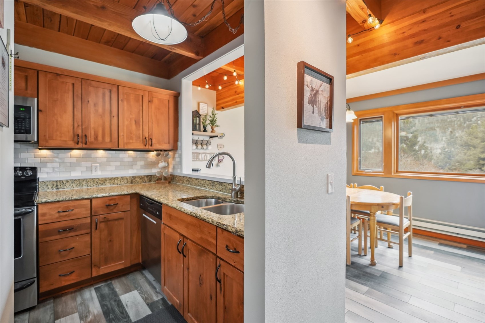 530 Tennis Club Road, Unit 1328 Keystone, CO 80435 - Photo 11 of 43 Kitchen featuring light stone counters, appliances with stainless steel finishes, a sink, tasteful backsplash, and open concept into the dining area