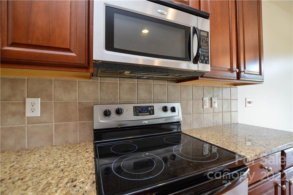 12110 Red Rust Lane Charlotte, NC 28277 - Photo 14 of 36 a kitchen with a stove and a microwave