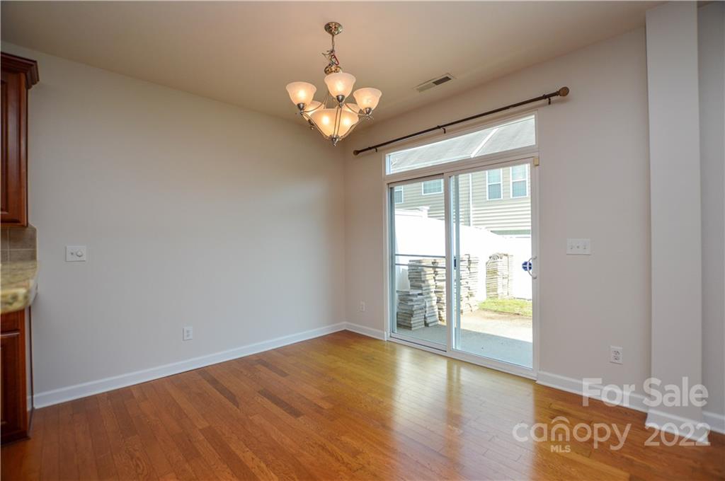 12110 Red Rust Lane Charlotte, NC 28277 - Photo 17 of 36 an empty room with wooden floor and windows