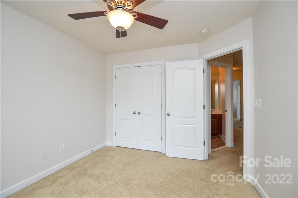 12110 Red Rust Lane Charlotte, NC 28277 - Photo 23 of 36 an empty room with closet and a chandelier fan