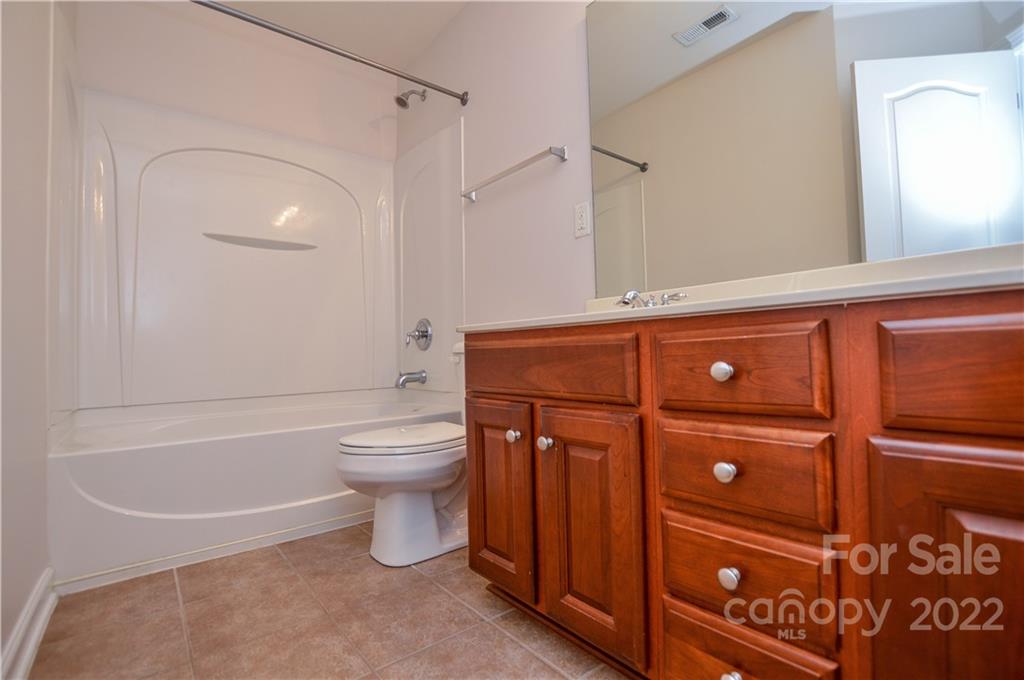 12110 Red Rust Lane Charlotte, NC 28277 - Photo 25 of 36 a bathroom with a granite countertop sink toilet and shower