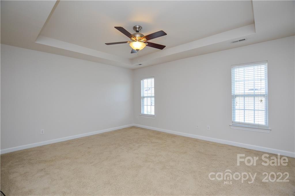 12110 Red Rust Lane Charlotte, NC 28277 - Photo 27 of 36 an empty room with windows and fan