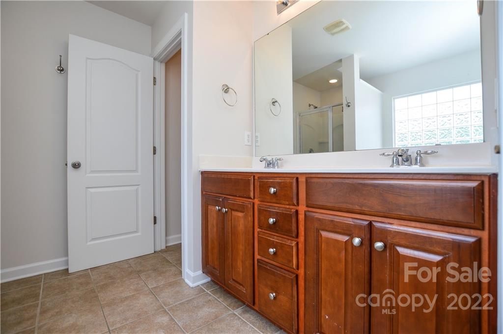 12110 Red Rust Lane Charlotte, NC 28277 - Photo 30 of 36 a bathroom with a sink vanity and a mirror