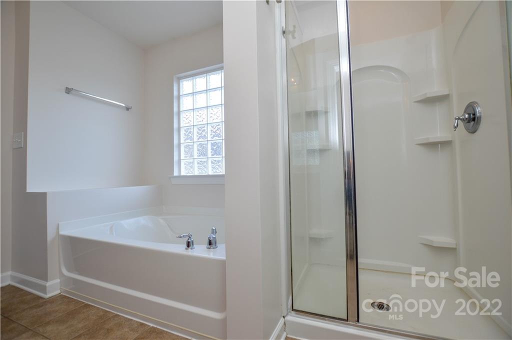 12110 Red Rust Lane Charlotte, NC 28277 - Photo 31 of 36 a bathroom with a bathtub and shower